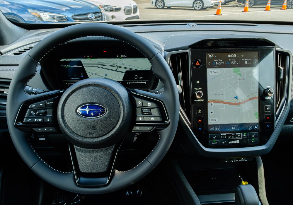 new-subaru-forester-interior.png Subaru Forester interior including the steering wheel. The infotainment system is also visible with a map pulled up on the screen