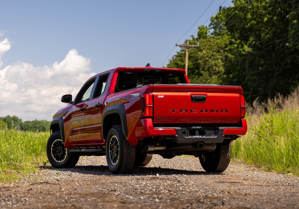 toyota-tacoma-towing-capacity.png Rear exterior view of a 2025 Toyota Tacoma for sale in Charlottesville. The truck is bright red