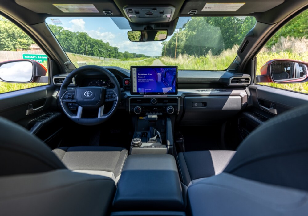 2025-toyota-tacoma-price.png Toyota Tacoma interior including the steering wheel and infotainment system