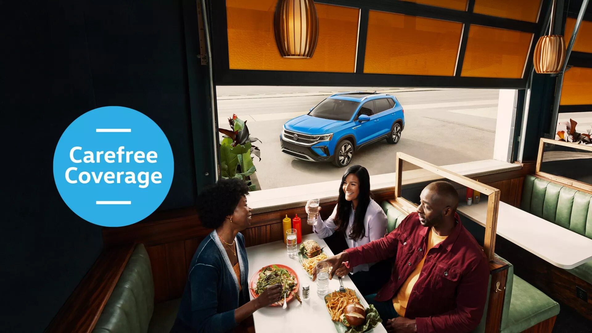 Carefree Maintenance .webp A group of people sitting inside a restaurant. Blue Volkswagen SUV parked on the street outside. Blue graphic that reads Carefree Coverage