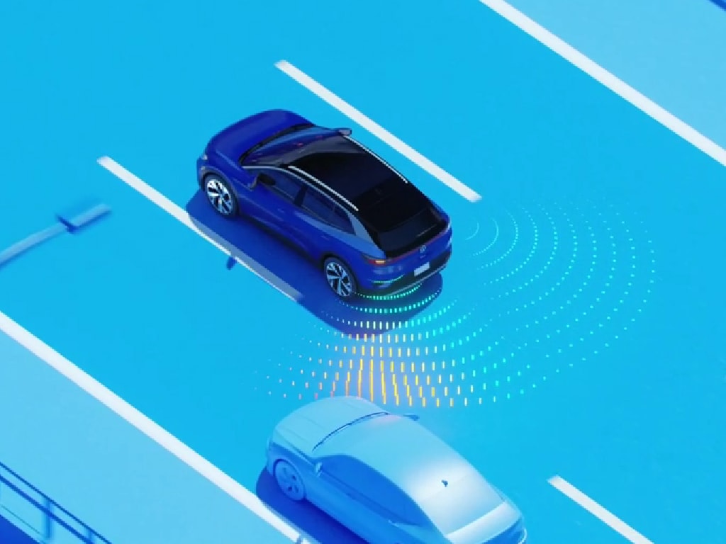 vw-active-blind-spot-moniter.jpg Volkswagen ID.4 driving on a three lane road. There is another car on the road, and the ID.4 is using active blind spot monitor