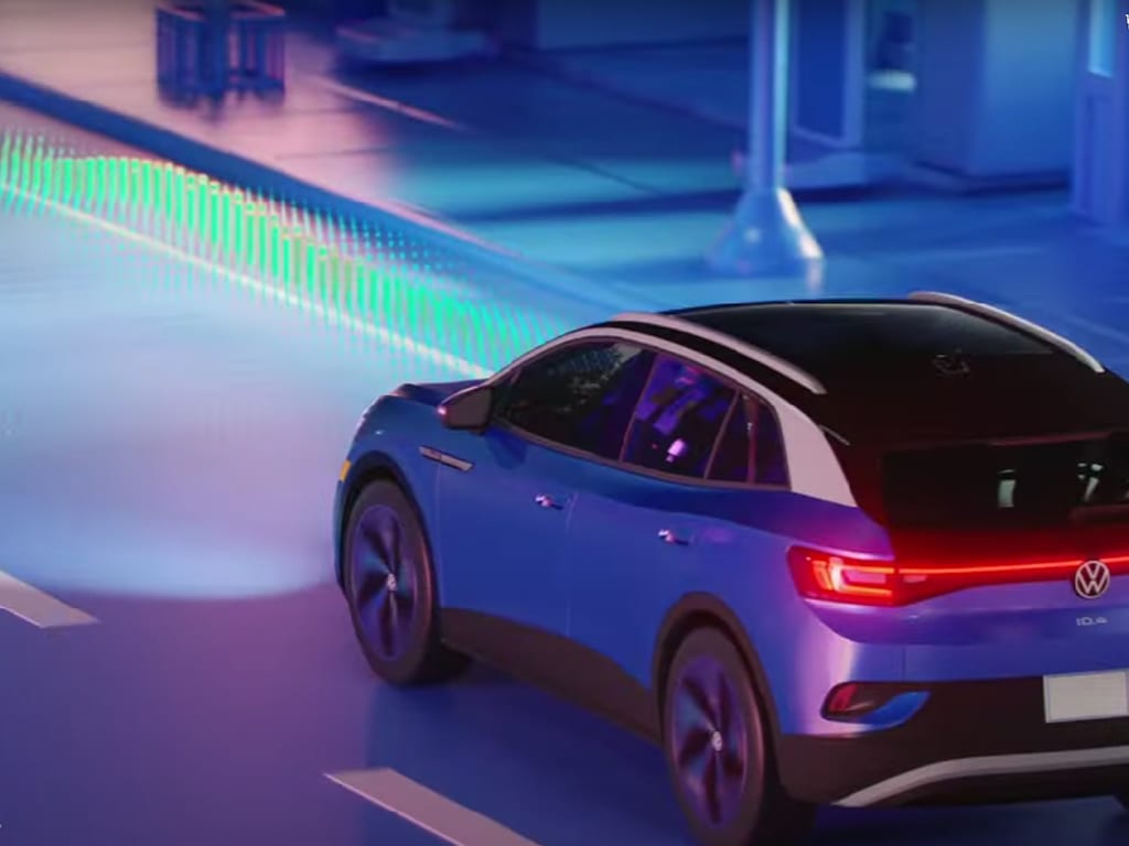 vw-smart-driver-assistance.jpg Blue VW ID4 on the road with its headlights on