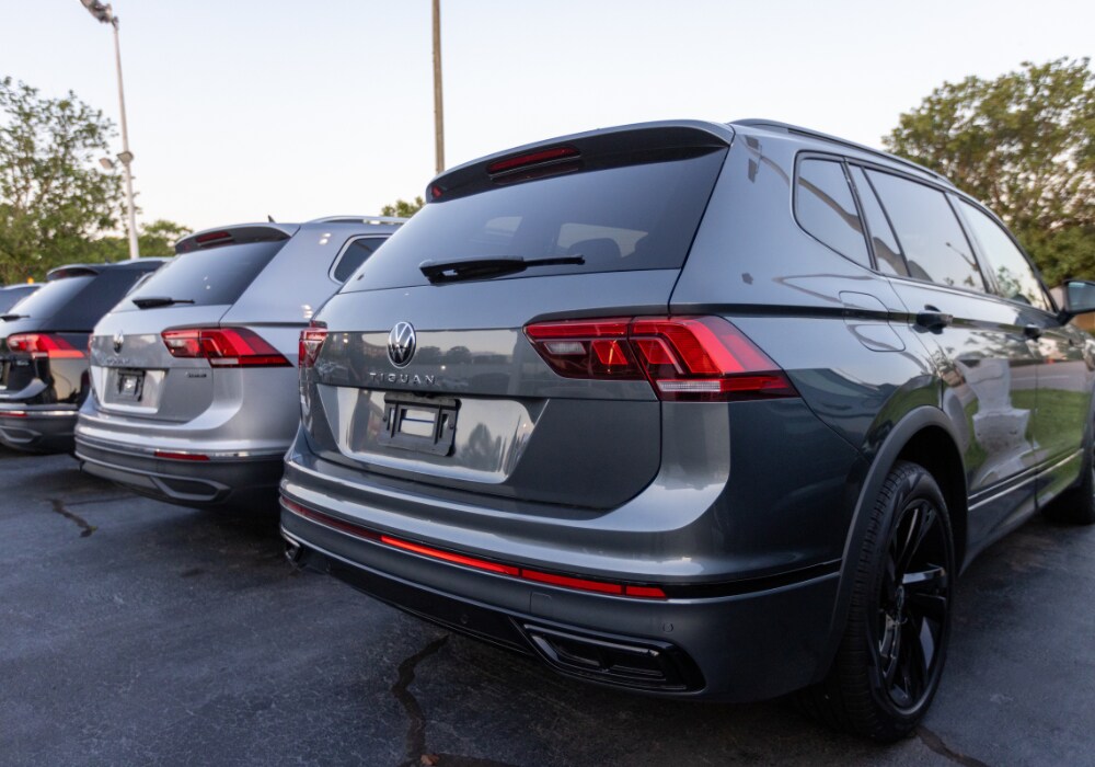 volkswagen-demo-vehicles-durham-nc.png Lineup of Volkswagen Tiguan SUVS for sale parked in the lot of Flow Volkswagen of Durham