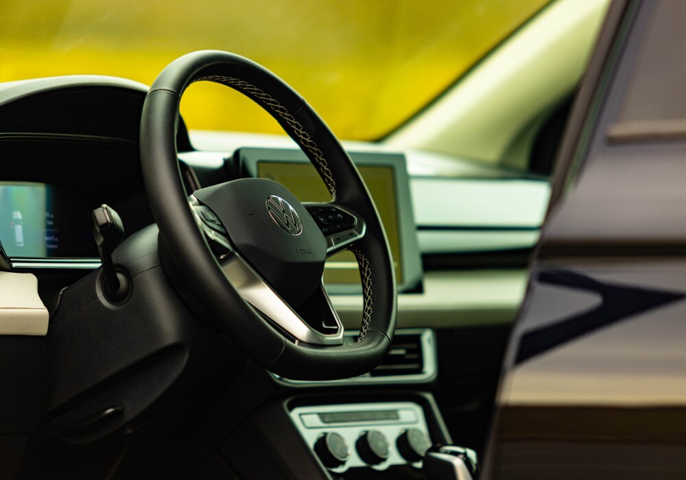volkswagen-taos-lease.png Volkswagen Taos interior including the steering wheel and infotainment system