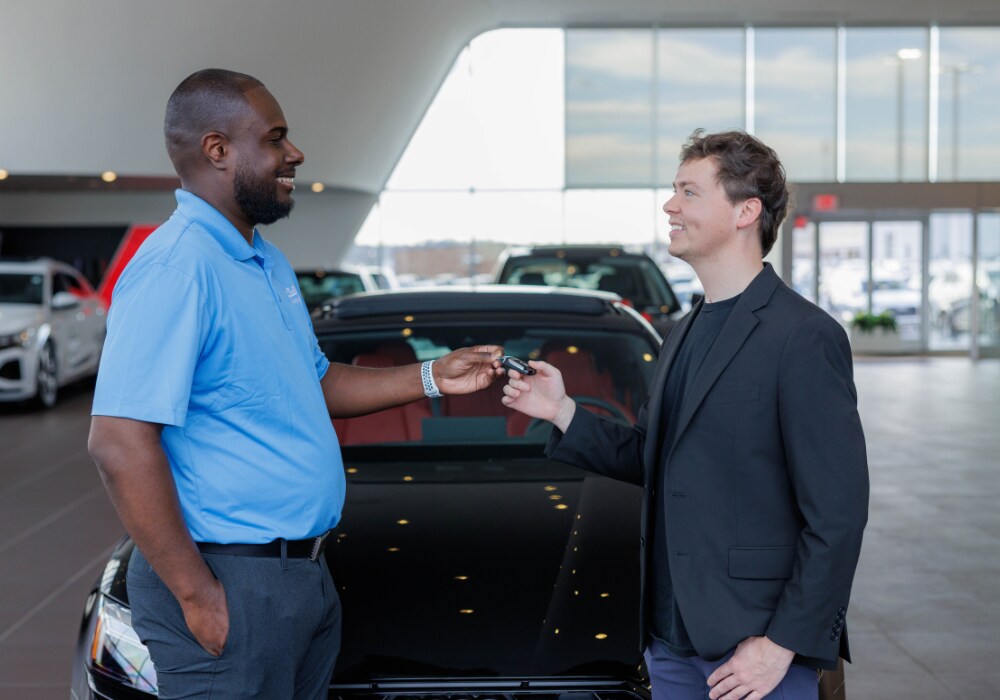 volvo-new-car-sales.png A Flow employee passing a key to a customer inside the Flow Volvo Cars Greensboro dealership