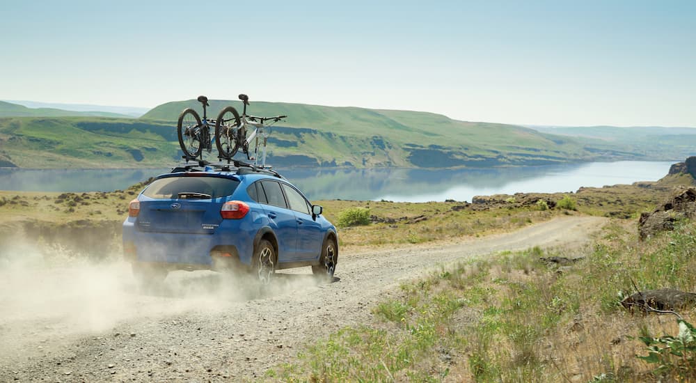 Certified pre-owned Subaru dealership - 2017 Subaru Crosstrek - Bikes Blue.jpg A blue 2017 Subaru Crosstrek is shown driving on a gravel road.