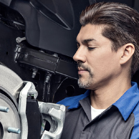 Person servicing the brakes of a vehicle