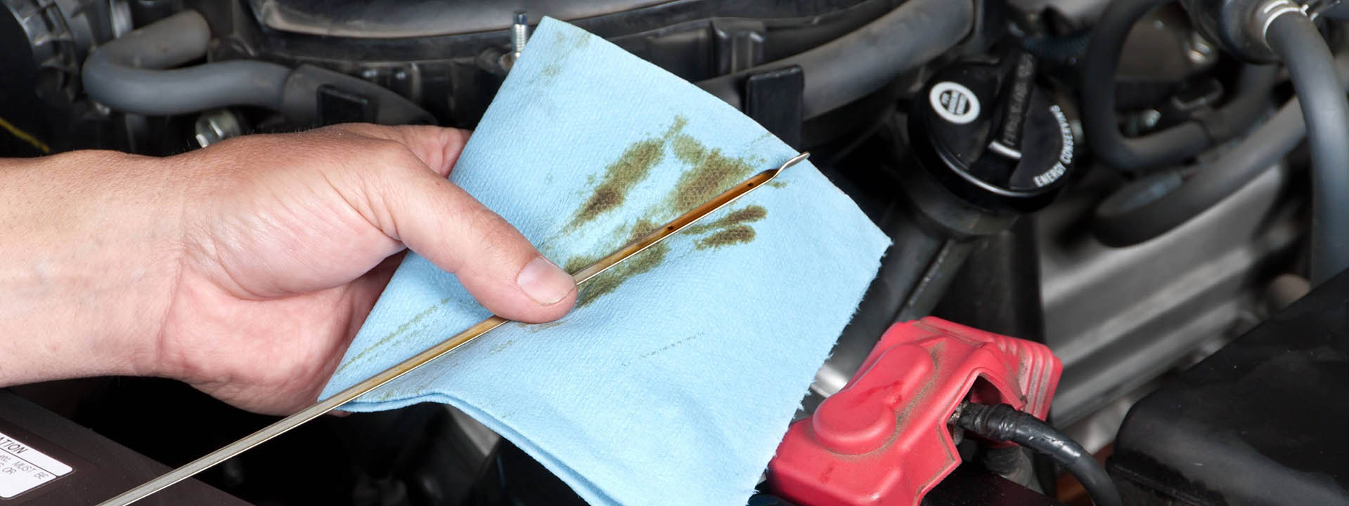 Auto Mechanic Checking Oil cropped banner
