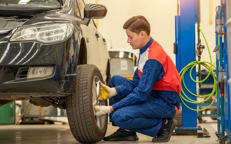 Service Technician Installing New Tires on a Dodger Car