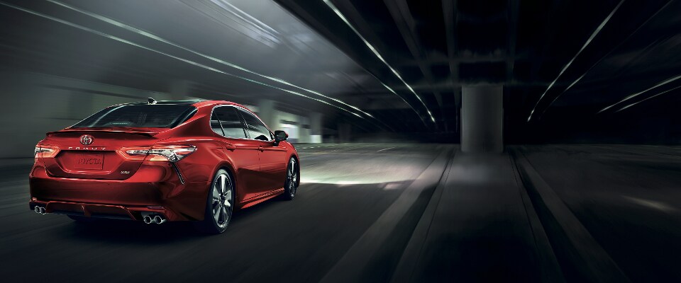 2019 Toyota Camry A red 2019 Toyota Camry driving on an underground road