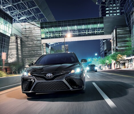 2019 Toyota Camry A black 2019 Toyota Camry driving down the road
