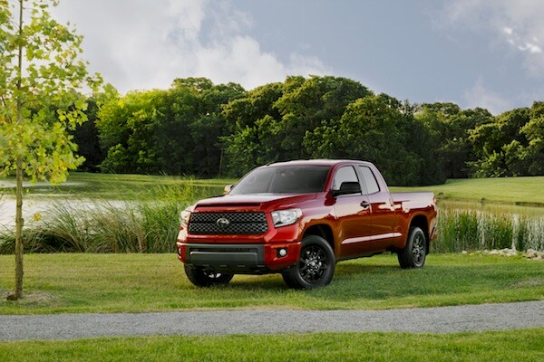 2019 Toyota Tundra A red 2019 Toyota Tundra parked in a large field by a lake