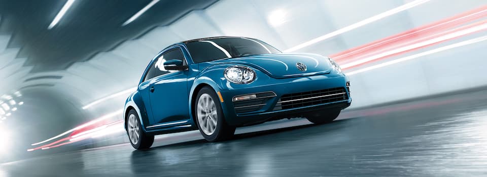 Volkswagen Beetle Model Differences Blue VW Beetle Driving In Tunnel