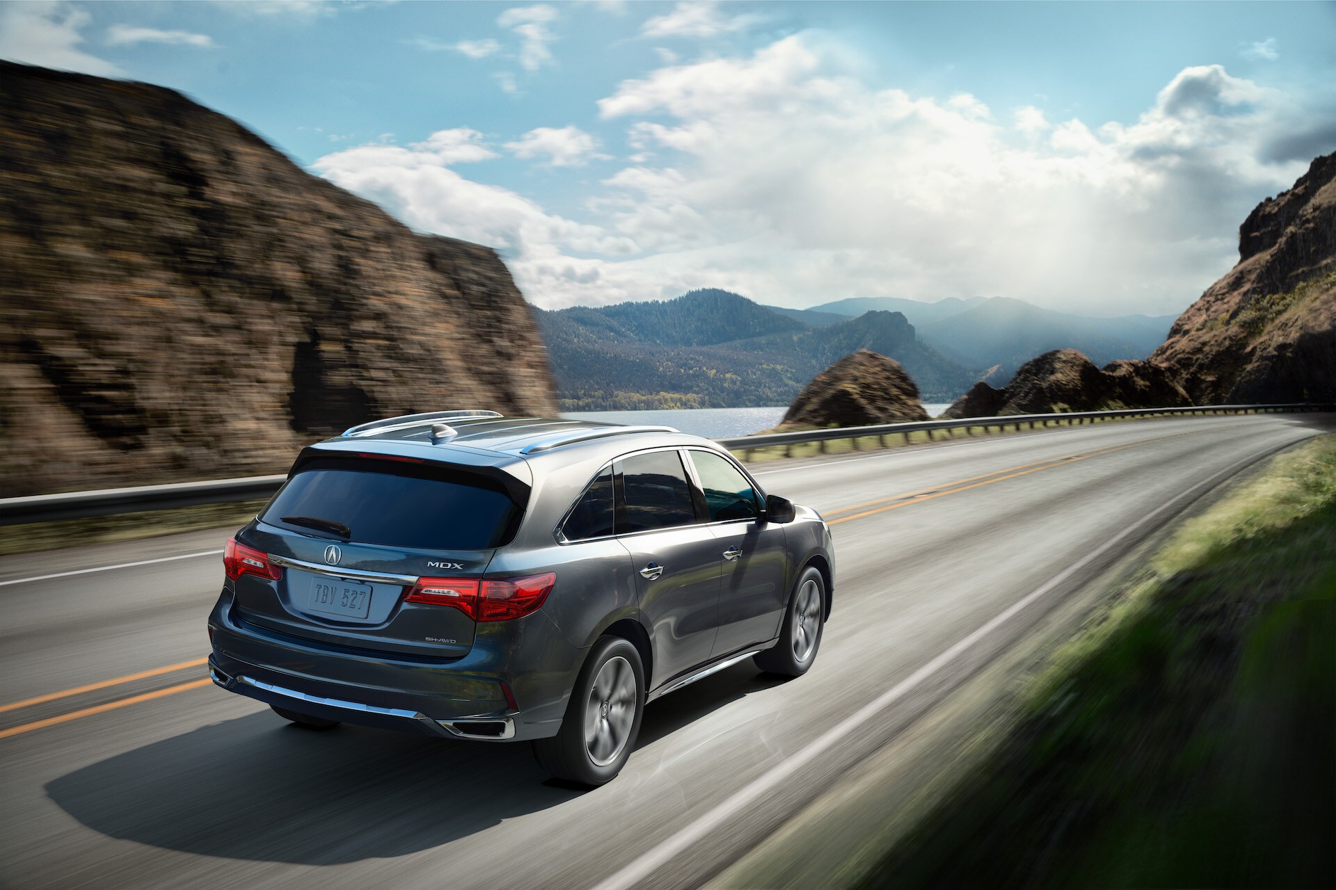 Compare the 2020 Lexus RX & the 2020 Acura MDX at Acura Hunt Valley | Gray 2020 Acura TMDX speeding away from camera on sea cliff road