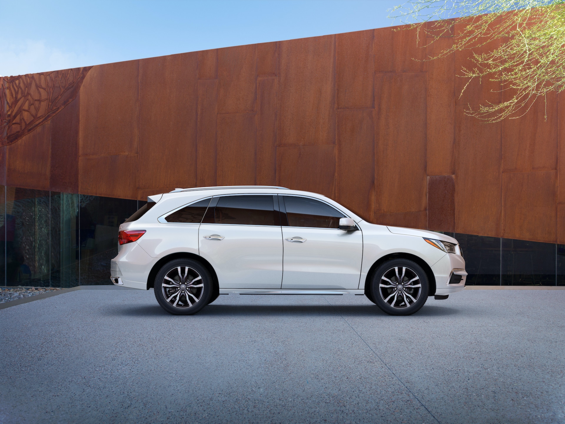 Comparison of the 2020 Acura MDX & 2020 Toyota Highlander at Acura Hunt Valley | Profile view of White 2020 Acura MDX parked by wooden wall