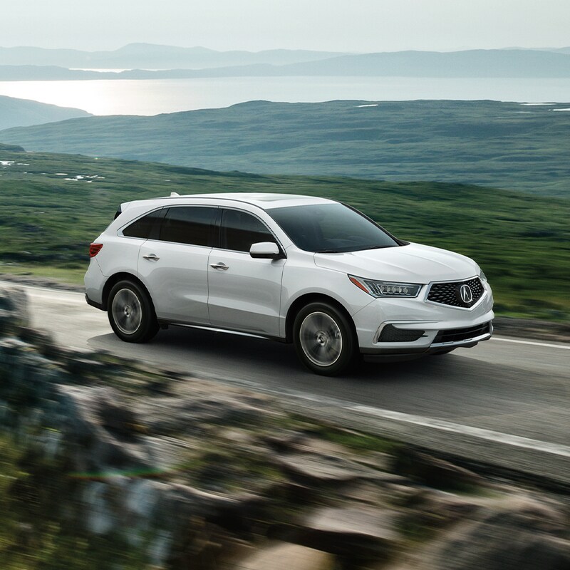 Buy from your Couch at Acura Hunt Valley | White 2020 Acura MDX Driving on Lakeside Road