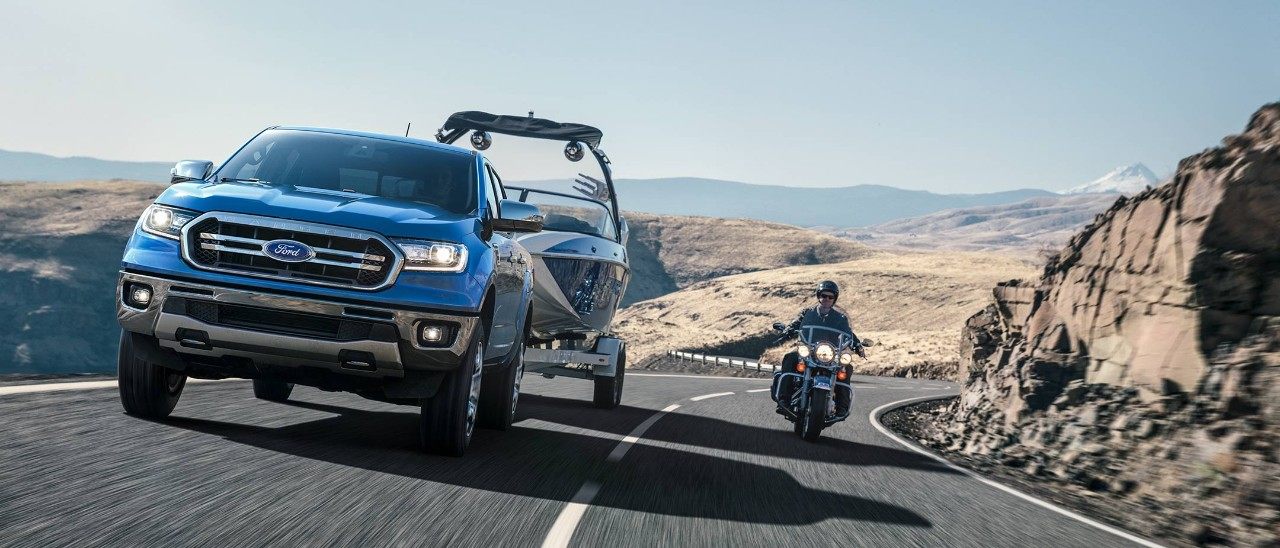 New 2019 Ford Ranger with Blind Spot Monitor Technology.jpeg New 2019 Blue Ford Ranger Pickup Truck with Blind Spot Monitor Technology Being Passed by a Motorcycle Rider
