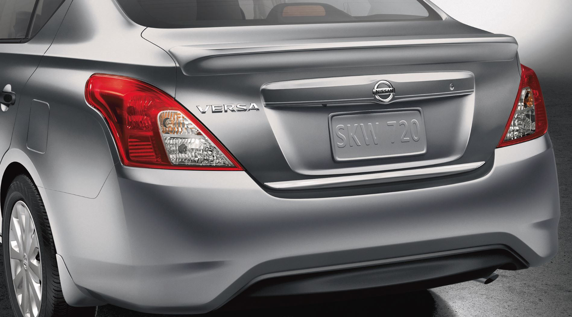 Silver Nissan Versa parked with no license plate.