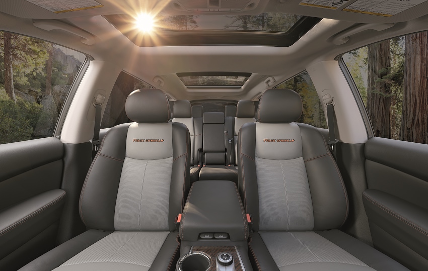 Nissan Pathfinder with black and gray interior showing sun shining through sunroof. Shows 3 rows in Pathfinder