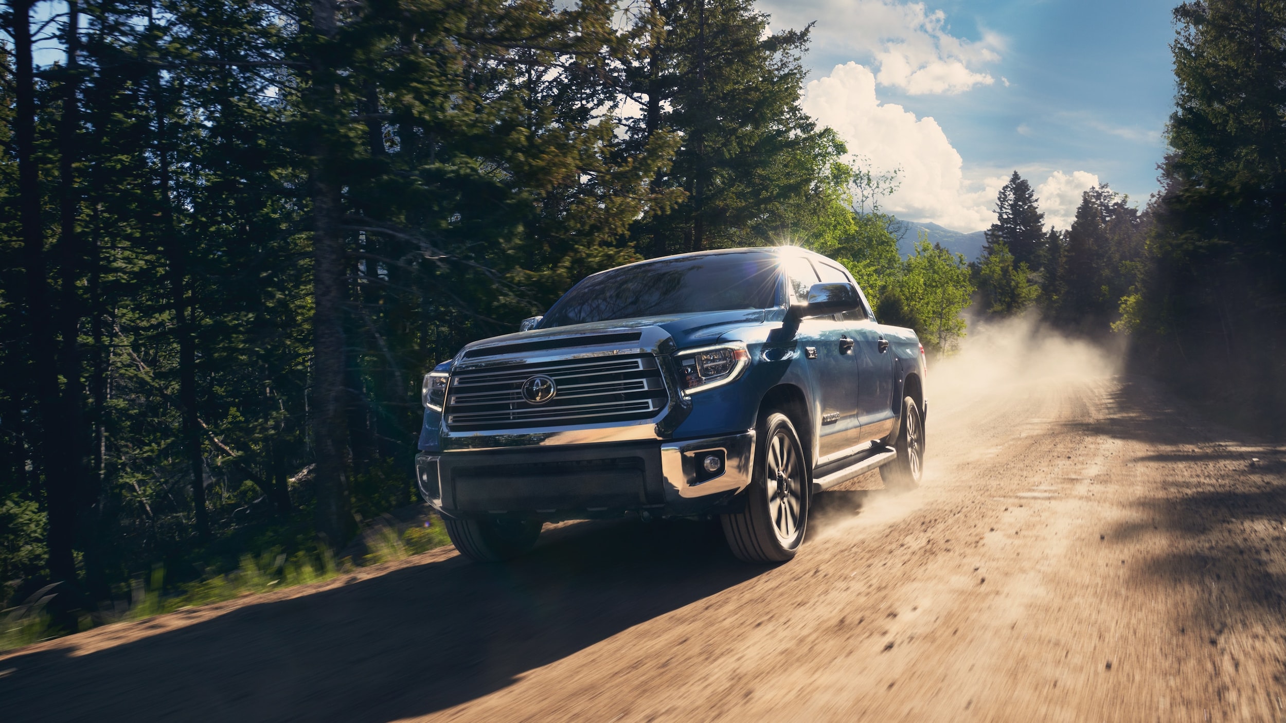 Blue Tundra Driving on Dirt Road