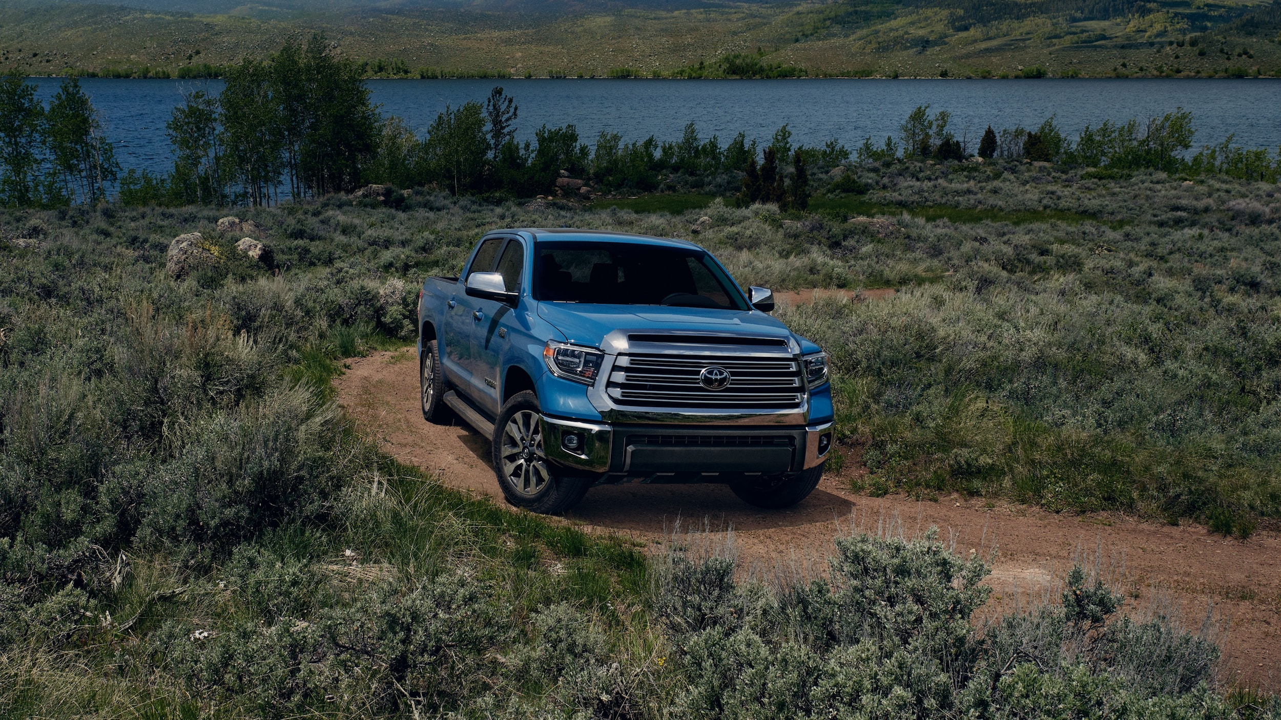 Blue Tundra Driving by Lake