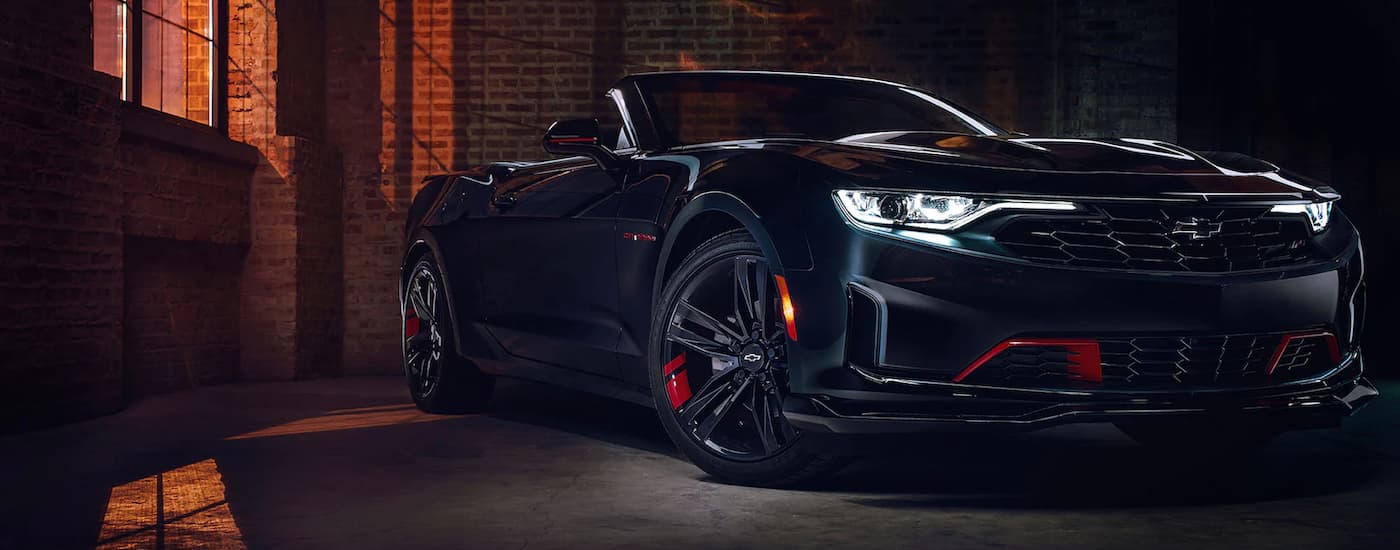 Sacramento Chevy Dealer - 2022 Chevy Camaro Redline - Warehouse.jpg A black 2022 Chevy Camaro Redline parked in a brick warehouse near a Sacramento Chevy dealer.