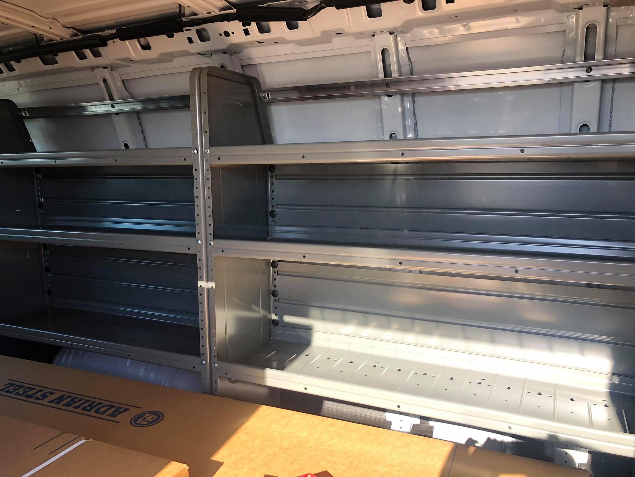 Interior view of a Chevy Express 2500 van with stainless steel bin package