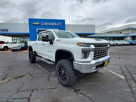 Front view of a white Chevy Silverado 2500HD with rough country lift package