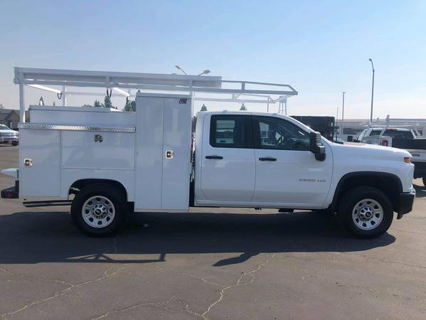 Side view of a white Chevy Silverado 2500HD double cab with Royal CTEC mechanic utility body