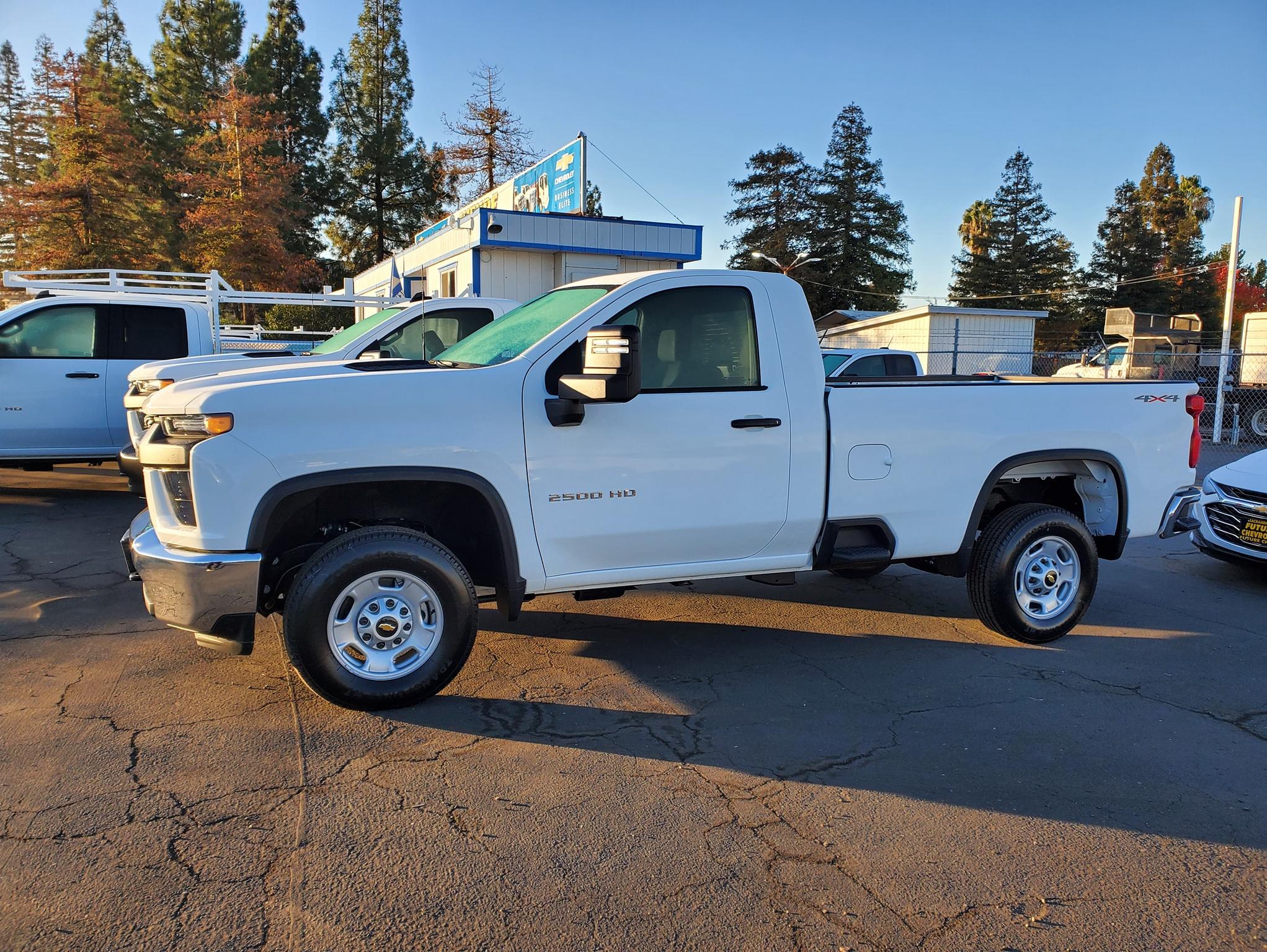Side view of a white Chevy Silverado 2500HD with regular cab and 8 foot bed