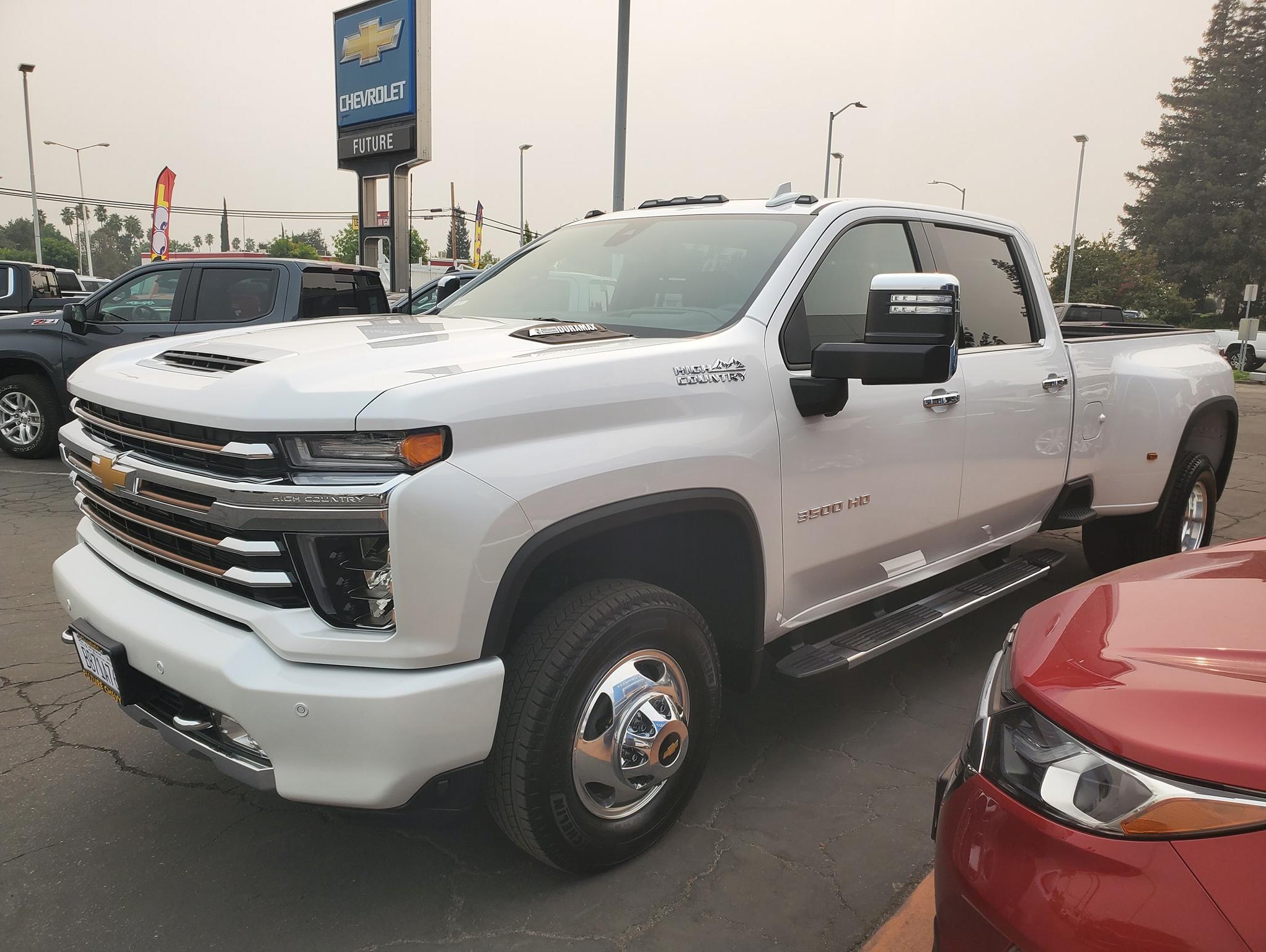 Front view of a Chevy Silverado 3500HD crew cab high country dually (DRW) in iridescent pearl