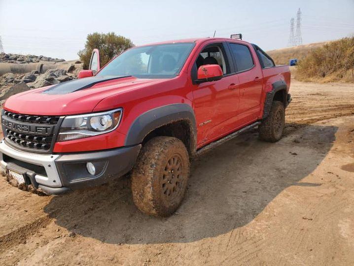 Red Chevy Colorado Bison parked on a dirt track