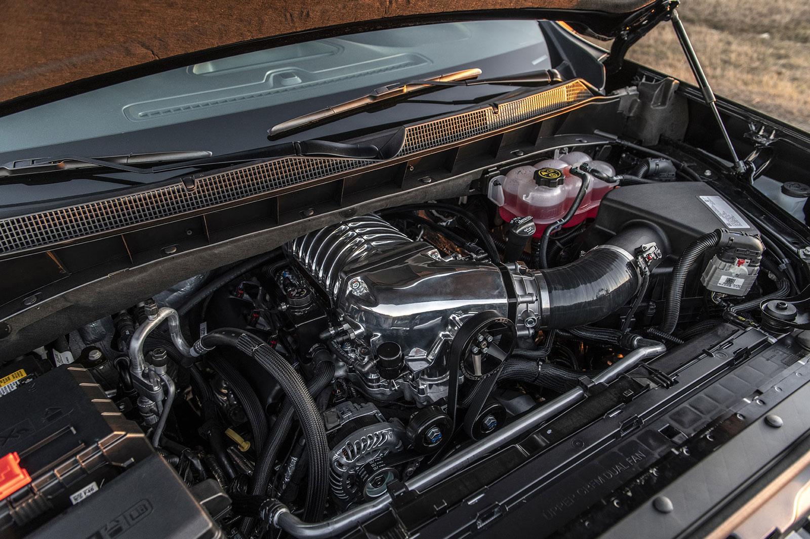 64126e2faa0e4dbbac4316ab8a6dbb88_1600x1066.jpg Black Chevy Silverado with its hood popped showing upgraded engine