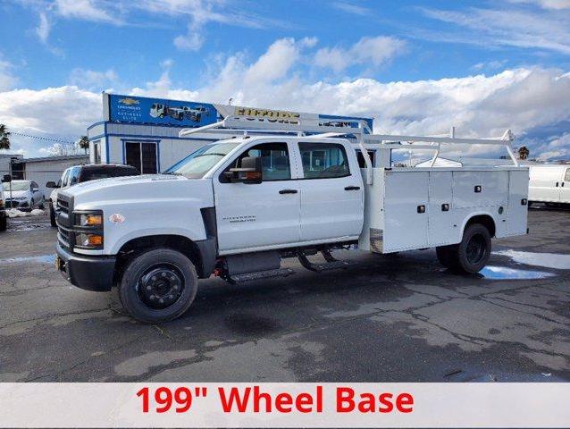 Side view of white 5500HD Silverado with Knapheide Utility Bed and 199 inch wheel base