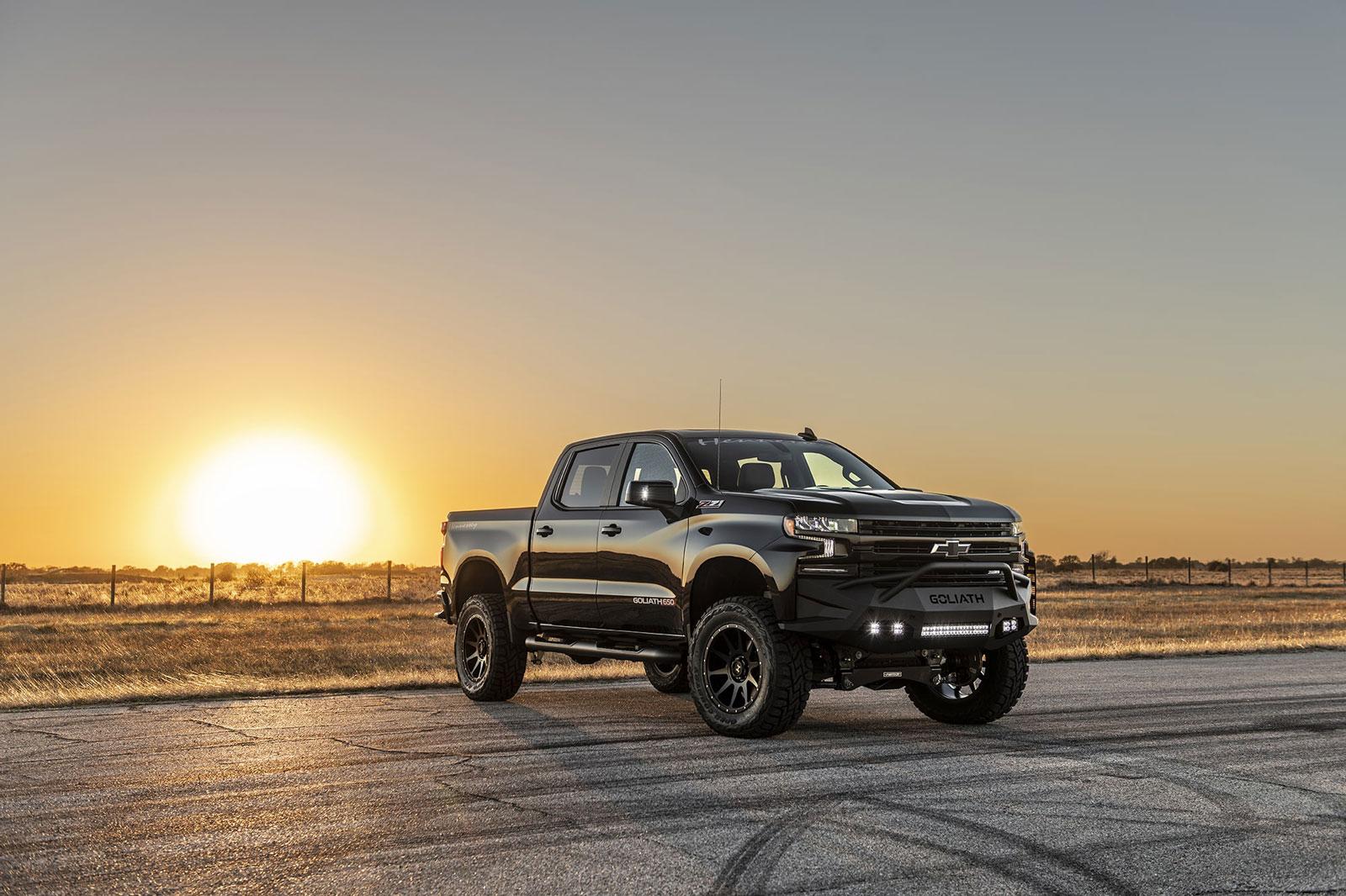 ae35a5bca711402d911780917a1cfd03_1600x1066.jpg Shiny black Chevy Silverado with Hennessey Goliath  650 Supercharged upgrades, from front right, in front of setting sun