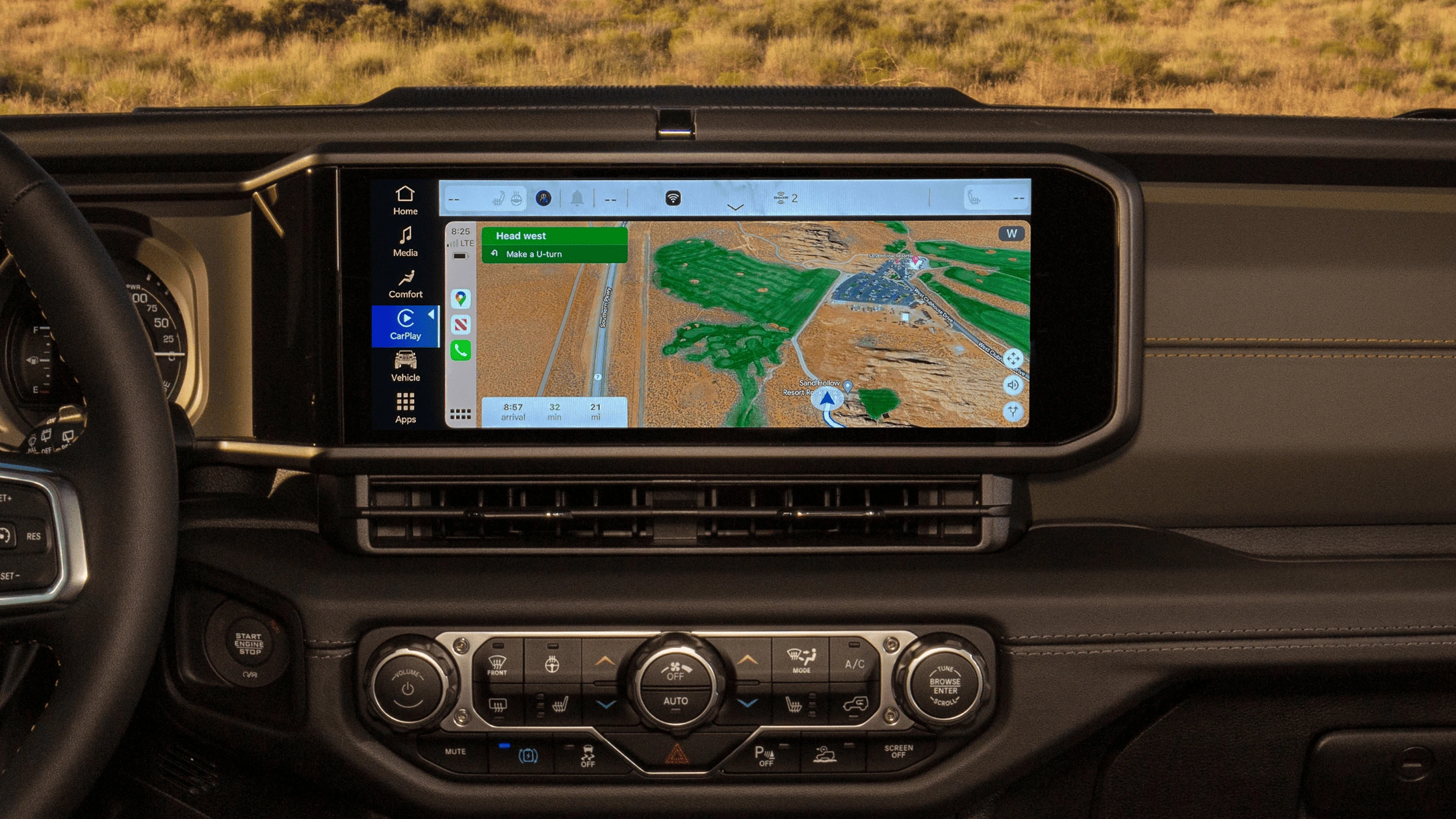 2025 Jeep® Wrangler 4xe - Interior and Technology Integration 2025 Jeep Wrangler 4xe open-roof interior with touchscreen and rugged terrain outside
