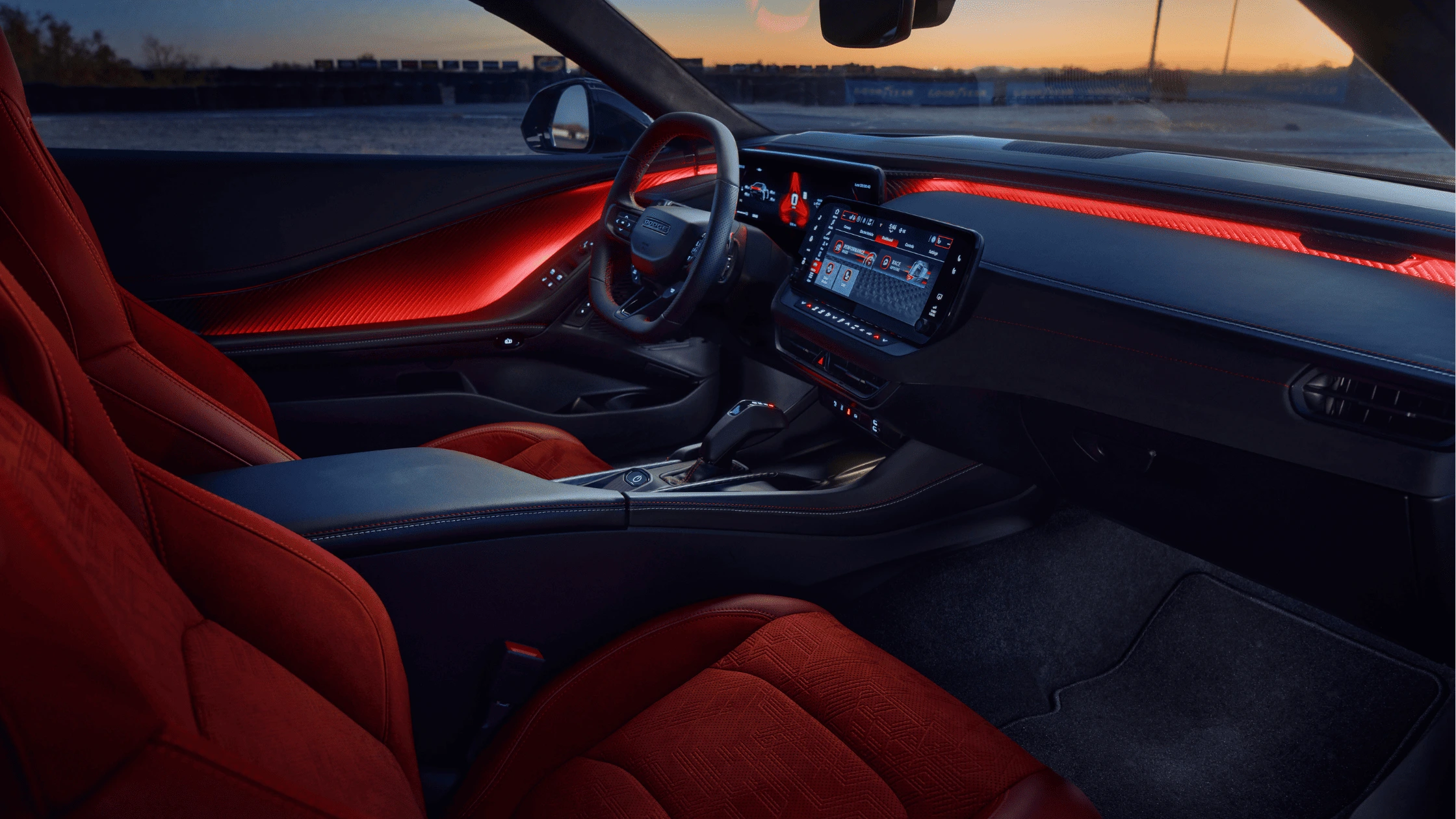 2024 Dodge Charger Daytona - Driver-Focused Interior with Advanced Technology Interior of a high-performance sports car with red ambient lighting, black and red upholstery, and a digital infotainment system, creating a futuristic and driver-focused cockpit.