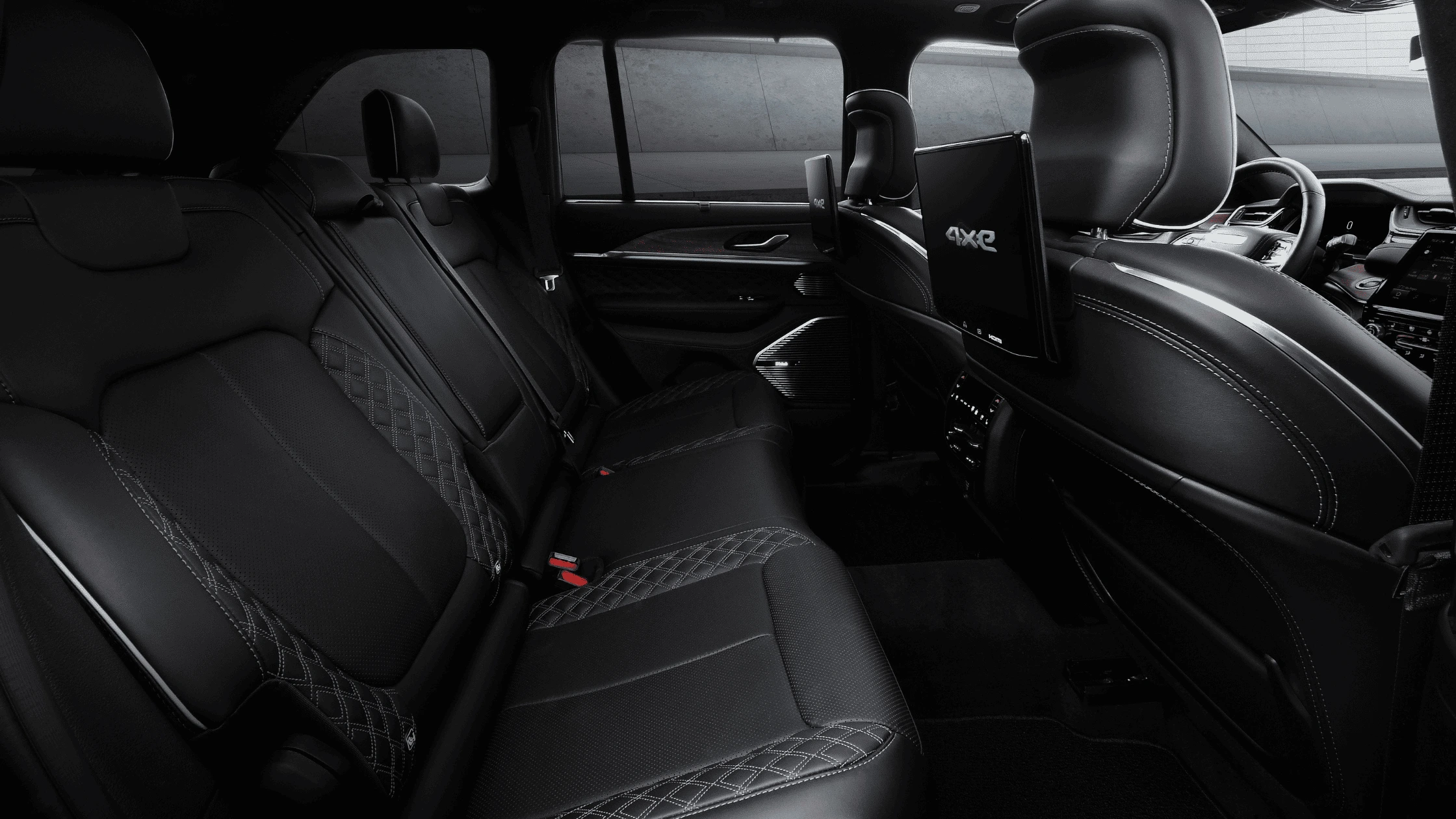 2025 Jeep® Grand Cherokee 4xe - Technology Systems Designed for Efficiency and Connectivity Jeep Grand Cherokee 4xe rear seats with entertainment screens and quilted leather