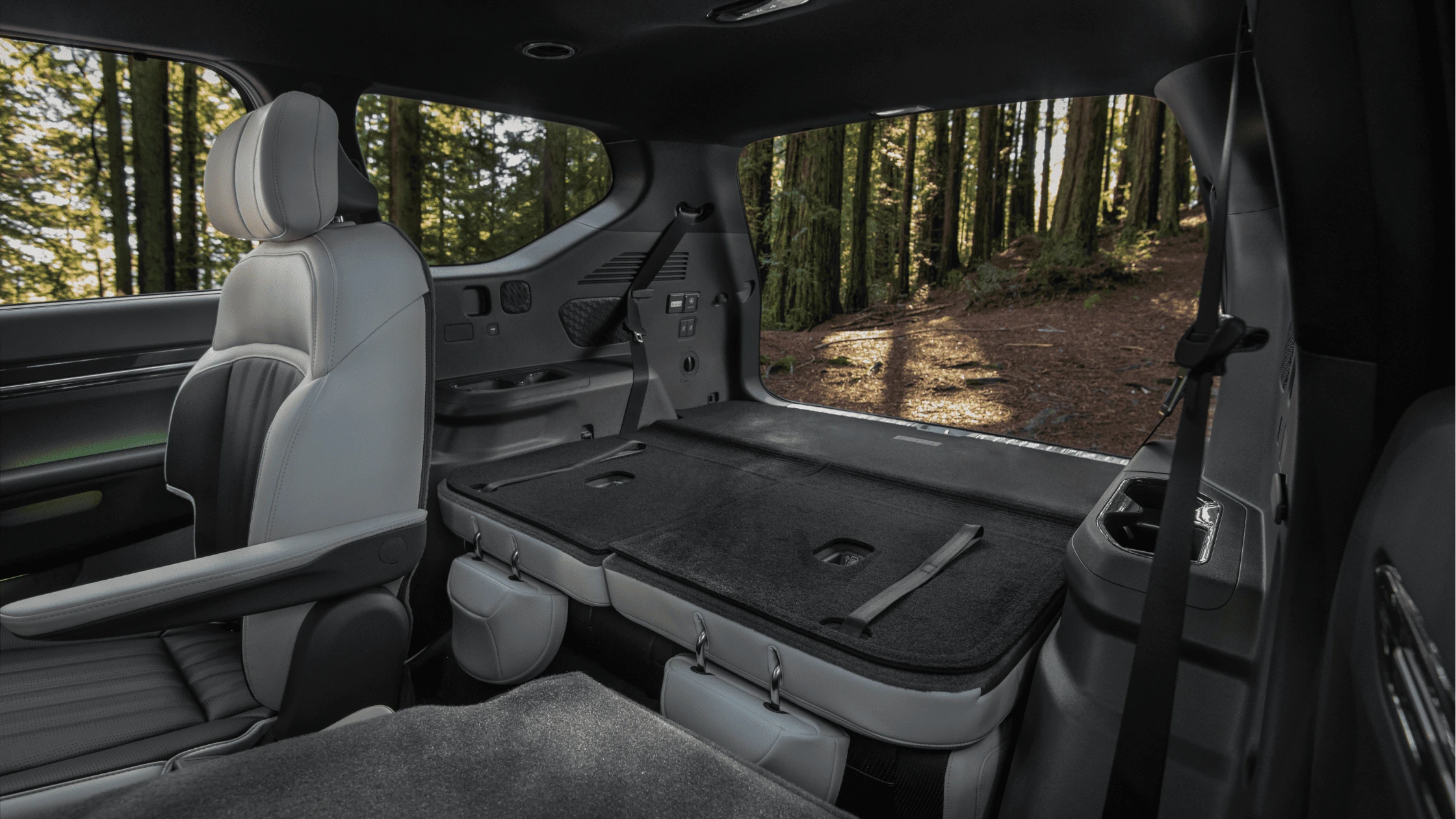2025 Kia EV9 - Cargo Management and Storage Volume 2025 Kia EV9 rear cargo area with folded seats showcasing spacious storage capacity