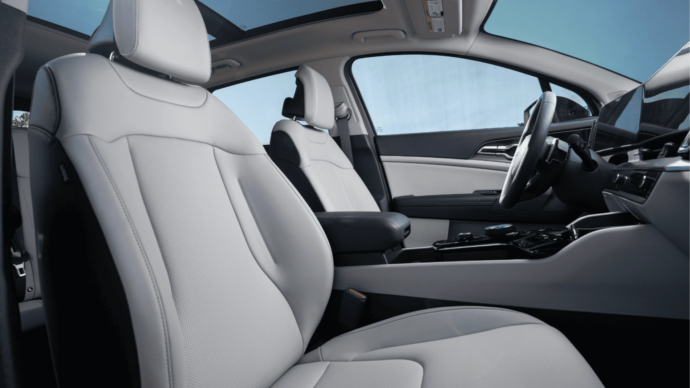 2025 Kia Sportage Hybrid - Trim Levels and Configurations Spacious and premium interior of the 2025 Kia Sportage Hybrid, showcasing comfortable light-colored seats and a panoramic sunroof.