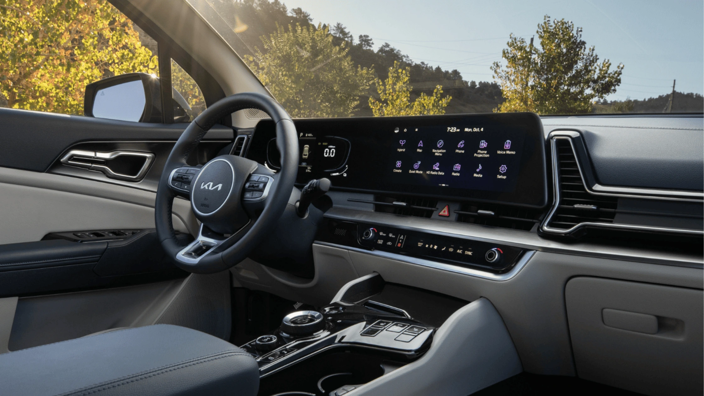 2025 Kia Sportage Hybrid - Technology and Infotainment 2025 Kia Sportage Hybrid interior with a digital dashboard and infotainment system, featuring a sleek steering wheel and modern controls.