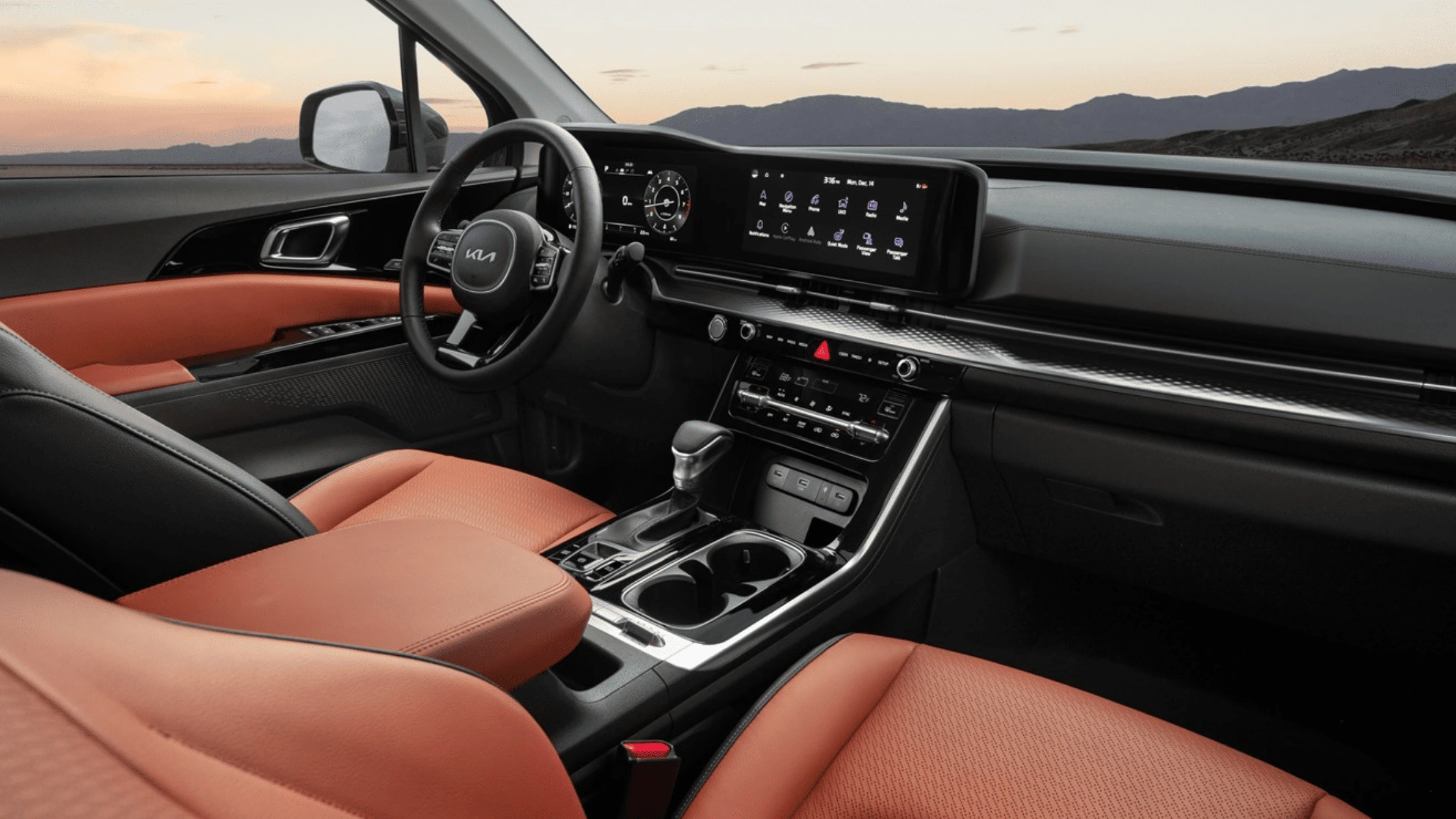 2024 Kia Carnival - Technology That Keeps You Connected Driver's seat view of the 2024 Kia Carnival interior, highlighting cutting-edge dashboard technology and premium seating for an enhanced driving experience.
