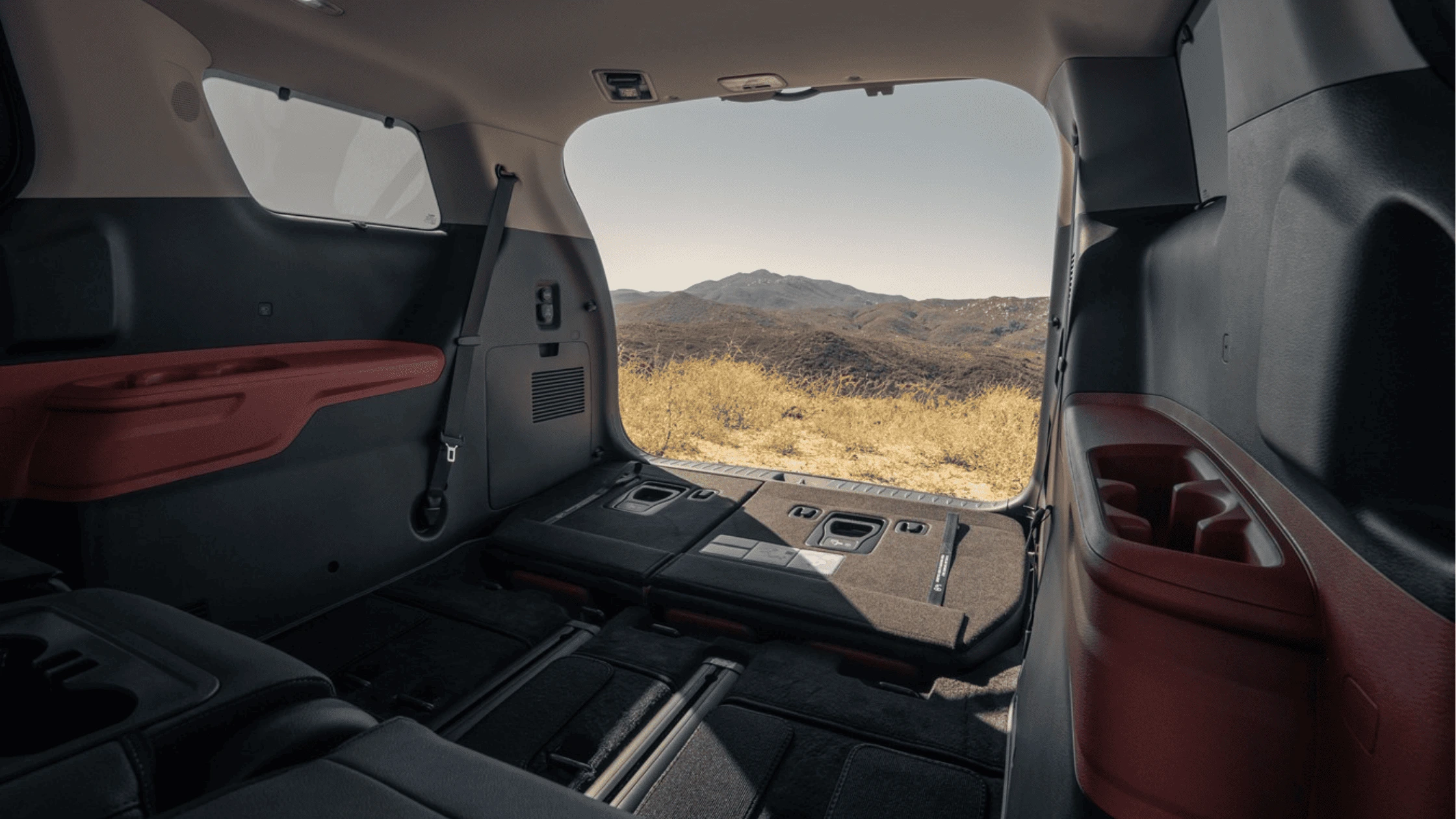 2025 Kia Carnival Hybrid - Panoramic Infotainment Interface and Rear-Seat Display Integration 2025 Kia Carnival Hybrid rear cabin with folded seats and panoramic rear cargo view