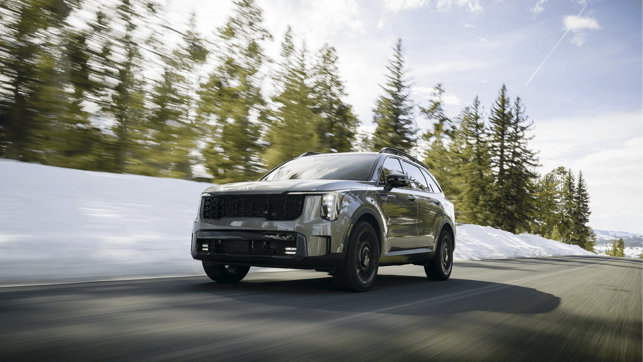 The 2025 Kia Sorento in Fort Myers, FL The 2025 Kia Sorento driving through snowy terrain, showcasing its sleek exterior design and winter driving capability.