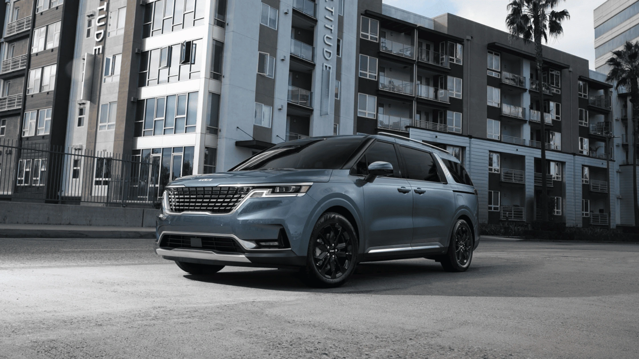 The 2024 Kia Carnival near Naples, FL 2024 Kia Carnival in sleek blue parked in an urban setting near Naples, FL, emphasizing its modern design and spacious family-friendly interior.