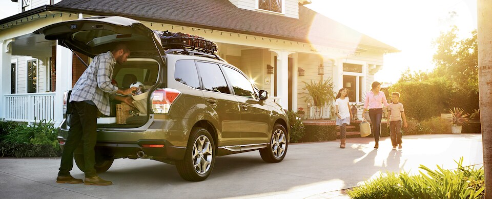 Subaru-Lifestyle Dad packing trunk of SUV with family on the way.jpeg