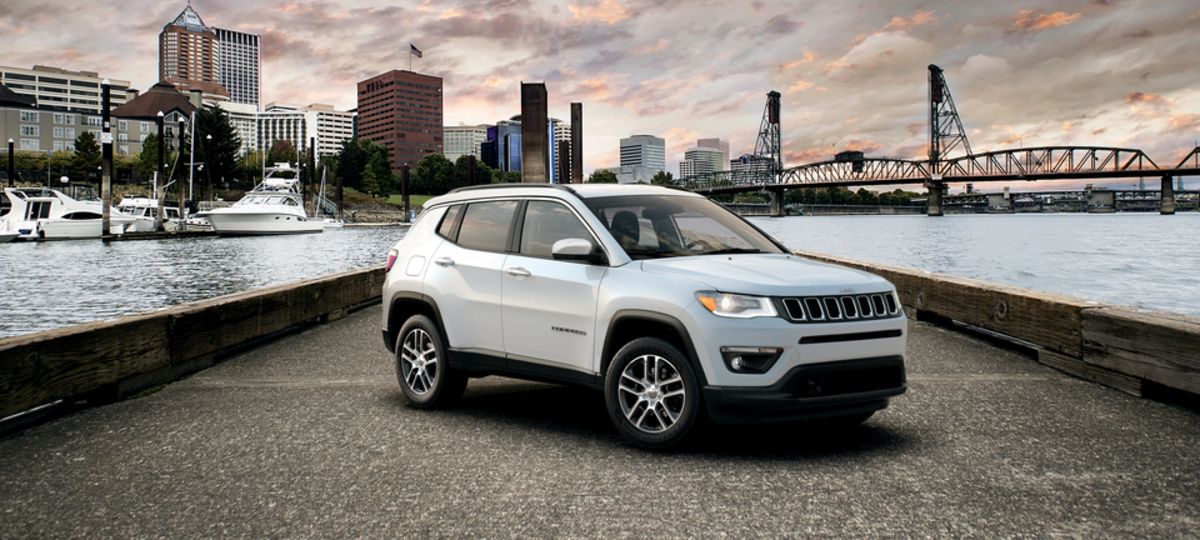 2021 Jeep Compass Latitude SUV white parked with city, dock and bridge in backbround_res.jpeg