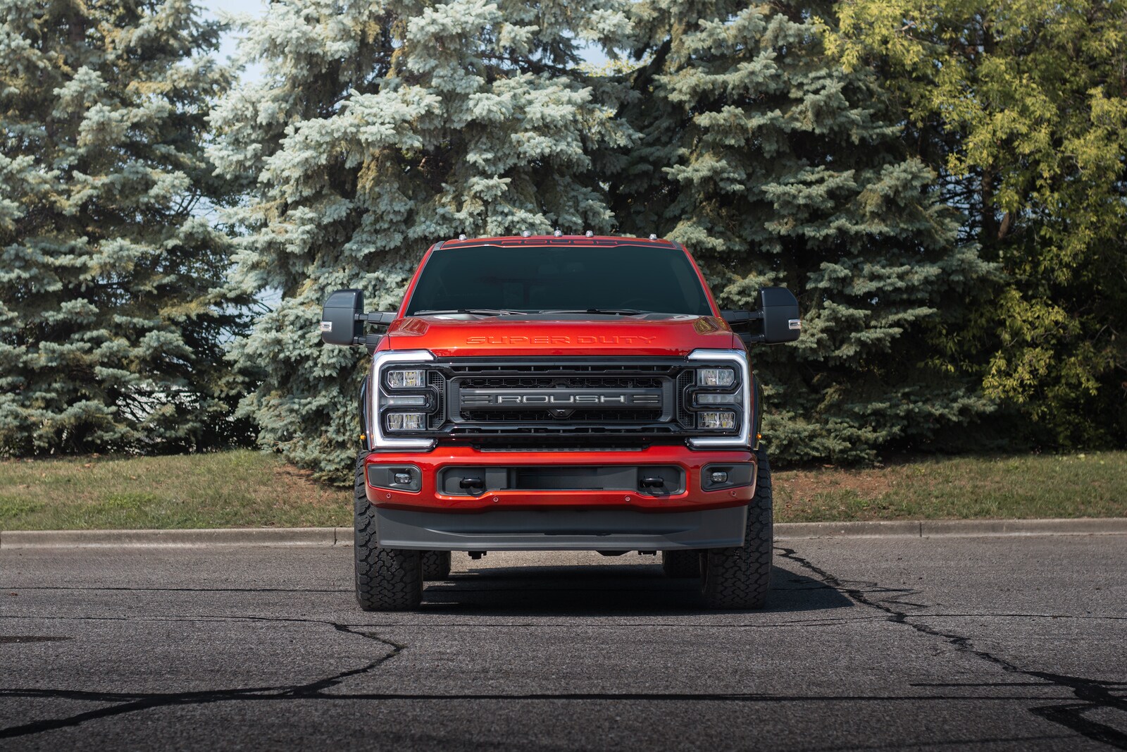Head-on Ruby Red ROUSH Super Duty with high-flow grille and roof marker lights