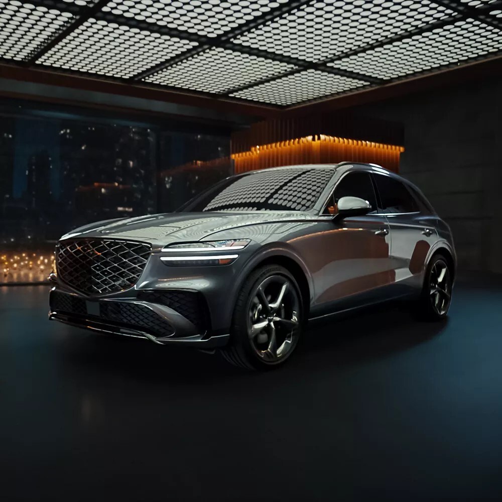 New Genesis GV70 parked in a luxurious studio at night New Genesis GV70 parked in a luxurious studio at night