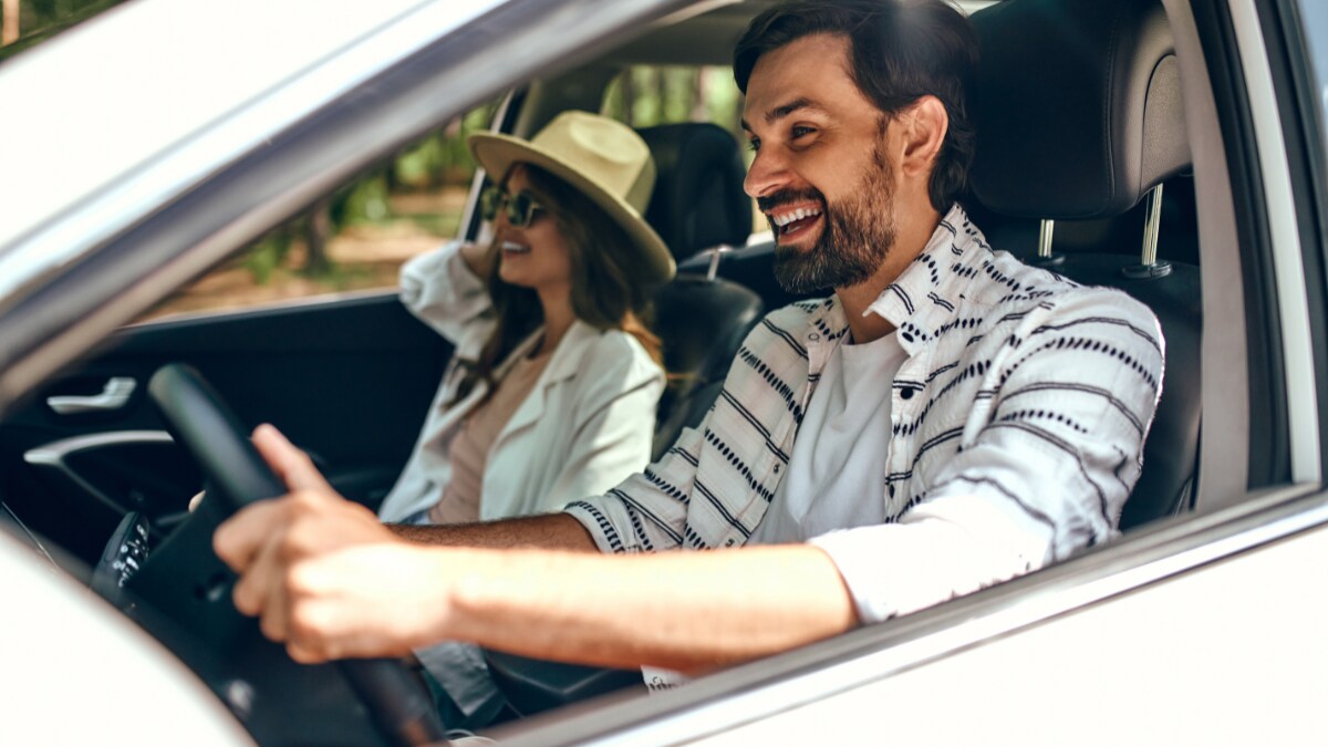 A smiling couple enjoying their new Genesis A smiling couple enjoying their new Genesis